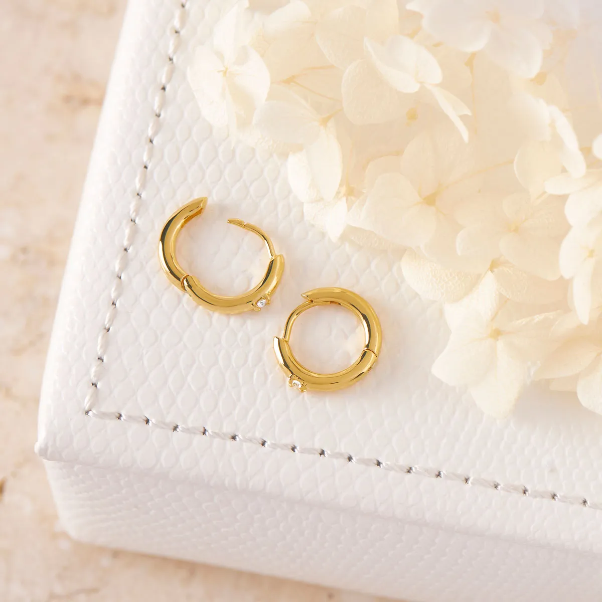 Comet White Topaz Huggies Gold