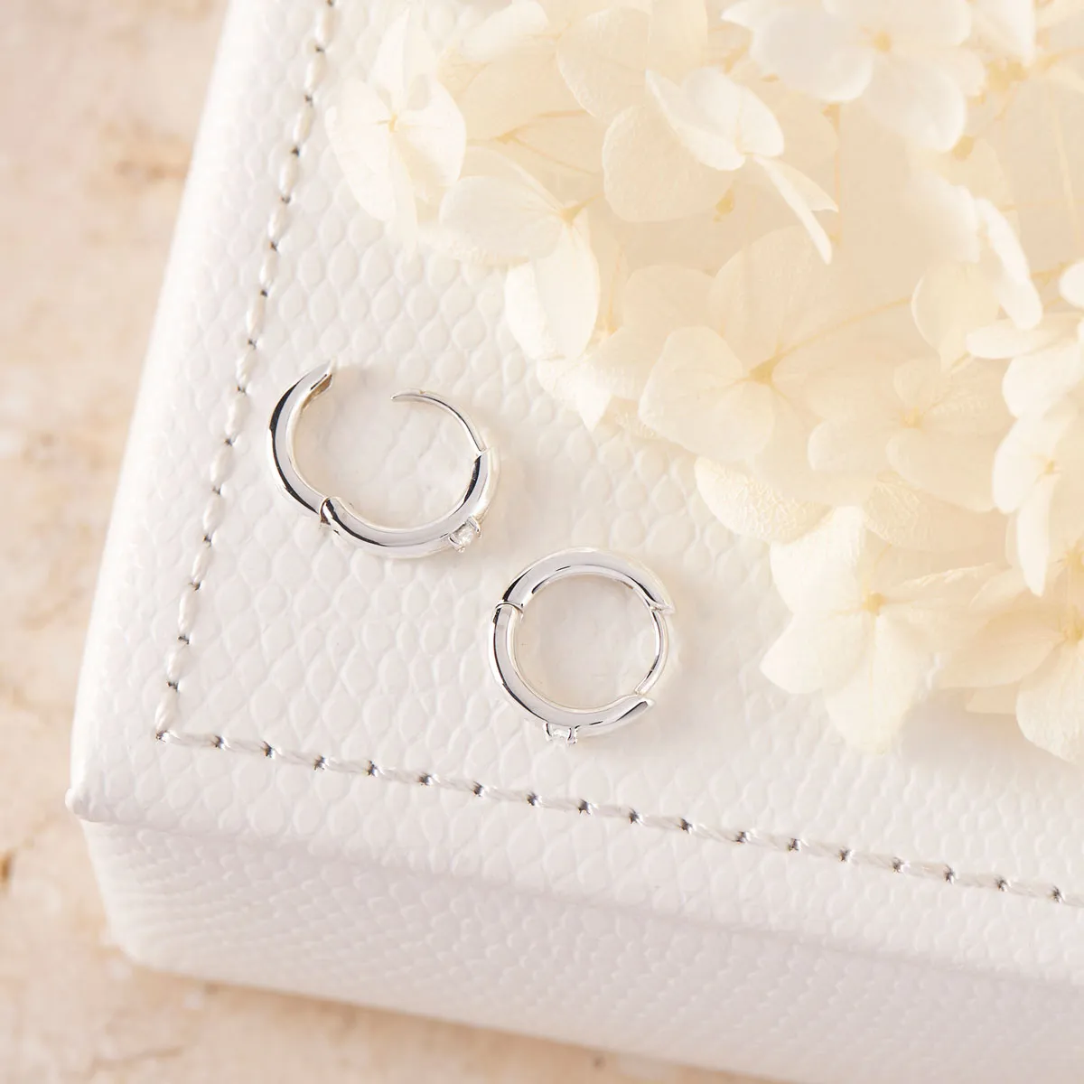 Comet White Topaz Huggies