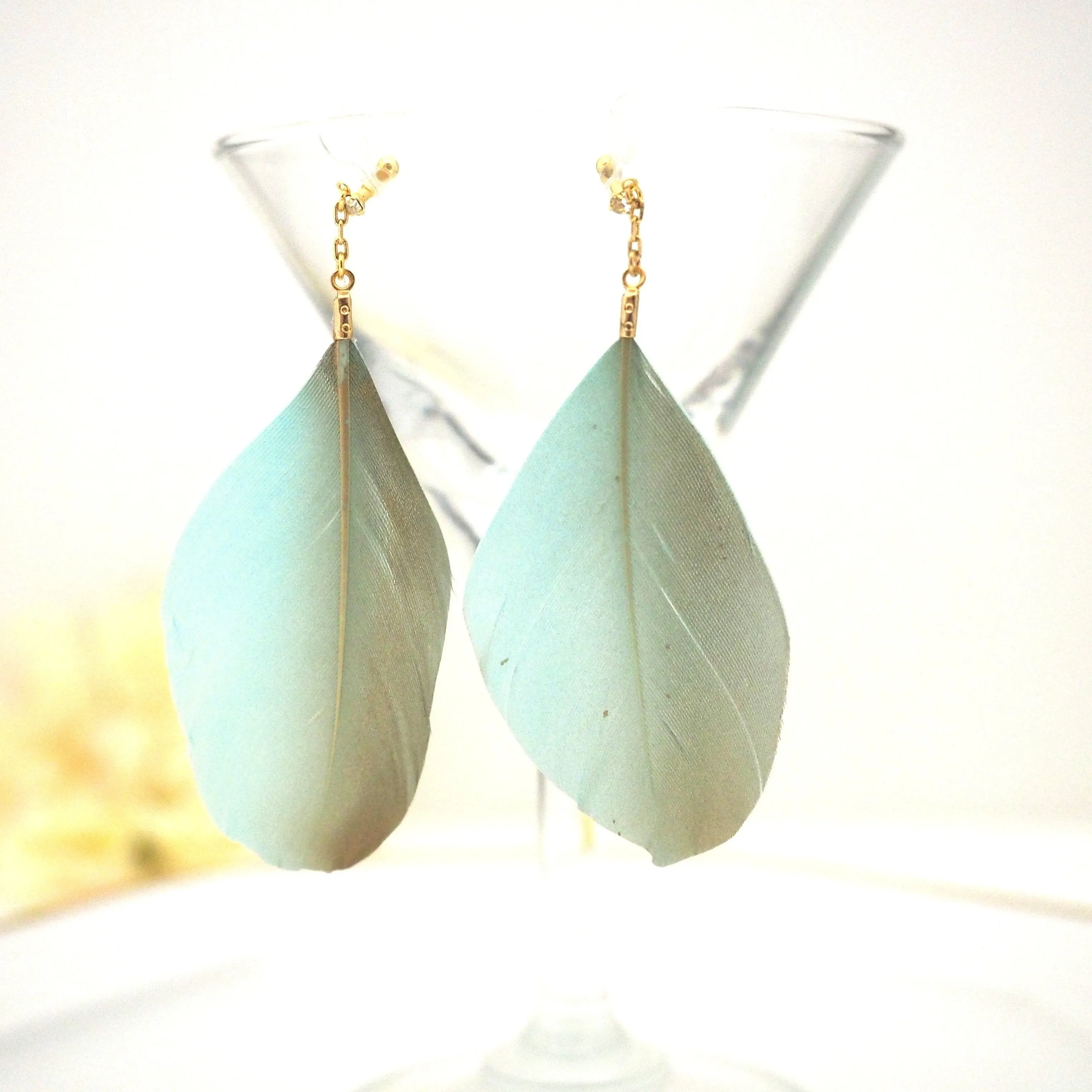 Gold painted green feather invisible clip on earrings